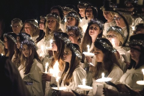 Girls taking part in a candle -lit festival