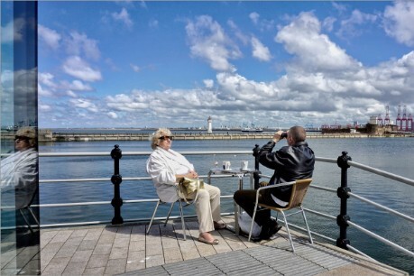 Two people enjoying the scene in different ways.