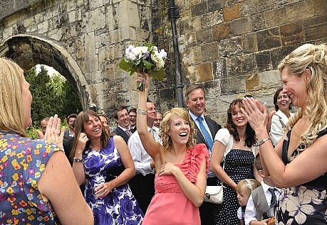 Married couple being showered with confetti.