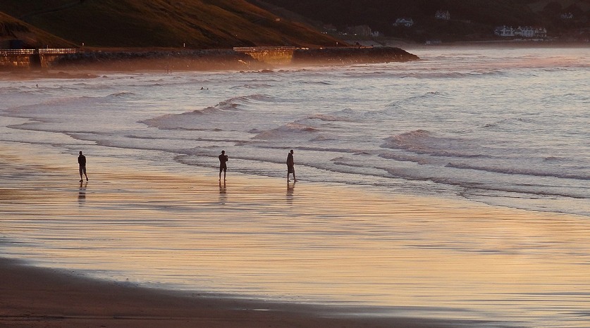 People on beach at sunset